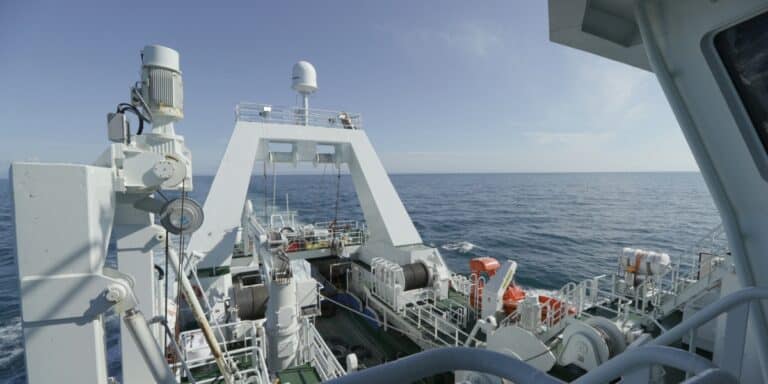 Commercial fishing vessel at sea equipped with satellite and monitoring equipment for AIS and VMS vessel data tracking